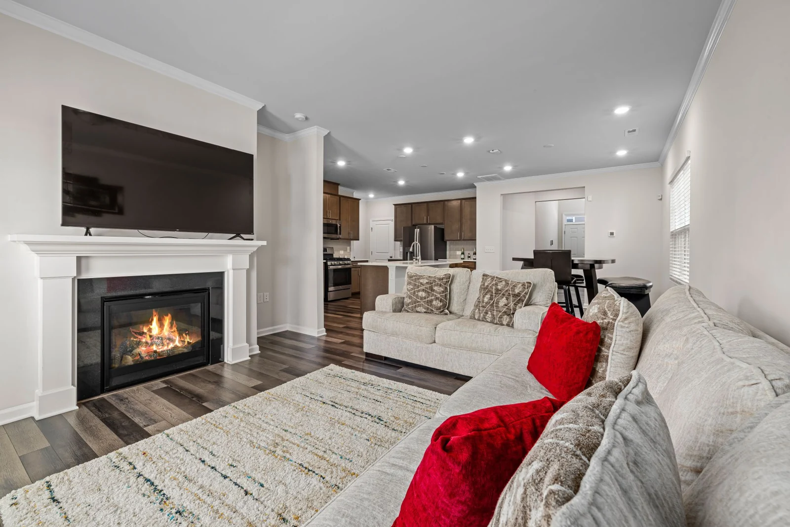 Contemporary fireplace beside seating with red cushions